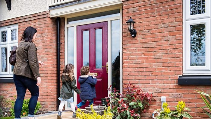 A family arriving at the front door of their new Davidsons home