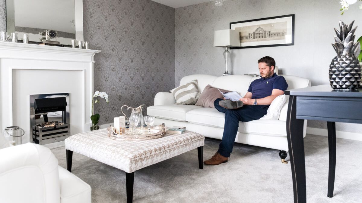 Reading through paperwork in a Davidsons living room
